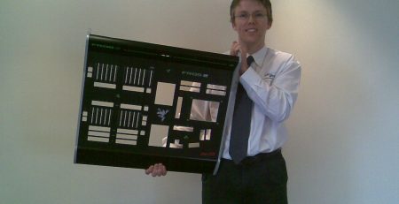 Staff photo of Paul holding large sheet metal fabricated part