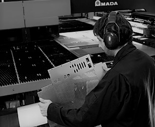 black and white image of a man cnc punching