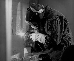 black and white image of a welder